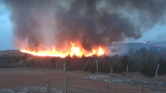 Crews from multiple fire departments are working to contain wildfires raging in Woodward and Dewey counties in northwest Oklahoma