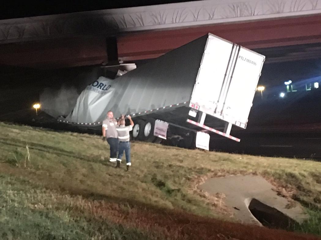 Emergency crews on the scene of a semi truck that crashed into a bridge in Norman