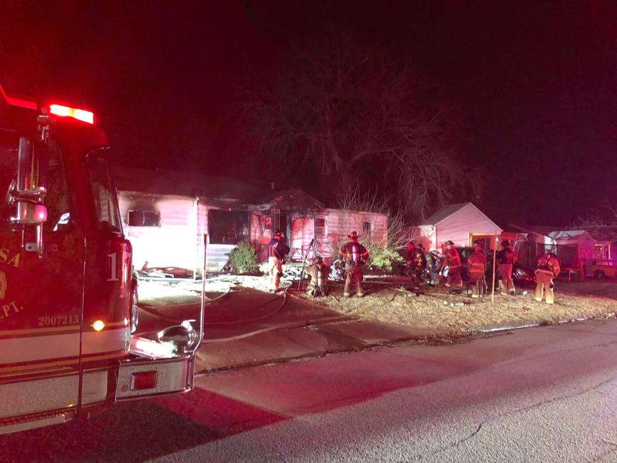 Smoke and flames are showing at the scene of a vacant house fire near 6700 East Jasper Street early Tuesday.