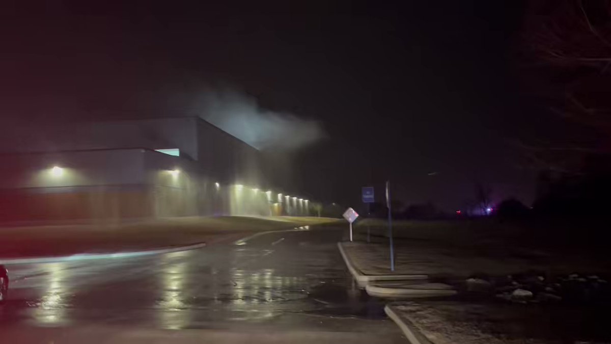 Scene at Hitachi in Norman. It appears the fire suppression system is damaged, you can see water spurting out from the building. The fire alarm is going off.   This is off of E Imhoff Rd